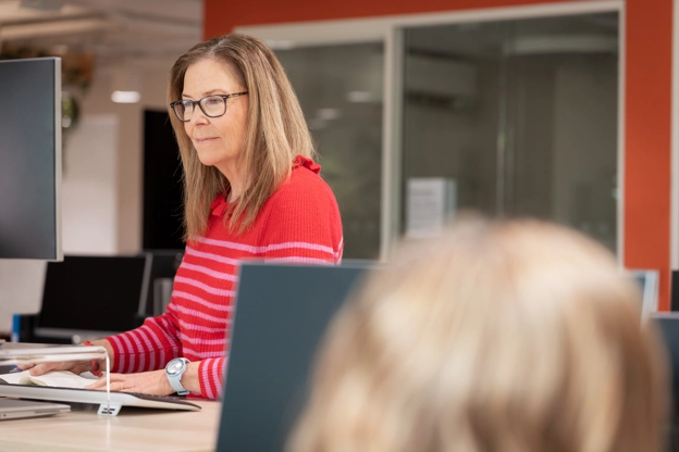 Woman in office looking at computer
